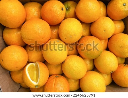 Stack of orange fruit at market.