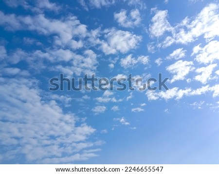 Beautiful white clouds and blue sky background. Blue sky with multitude small clouds in daylight. Tiny soft white clouds in the blue sky. Cumulus clouds in clear blue sky. Nature concept background