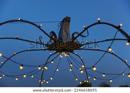 Halloween decoration lights during sunset in Italy.