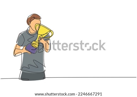 Single one line drawing young male athlete wearing jersey kissing national sports competition championship trophy. Proud achievement. Modern continuous line draw design graphic vector illustration