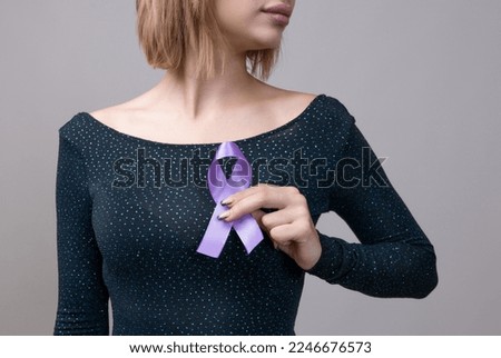 Woman holding a purple ribbon in her hands ADD,ADHD,Alzheimer Disease ,Arnold Chiari Malformation,Childhood Hemiplegia stroke, Epilepsy, Chronic Acute Pain,Crohns Royalty-Free Stock Photo #2246676573
