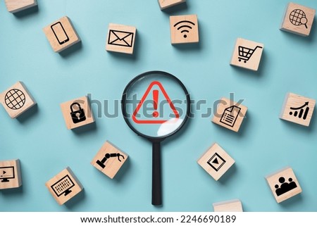 Magnifier glass with red triangle caution warning sign and technology icons  for notification error and maintenance support concept. Royalty-Free Stock Photo #2246690189