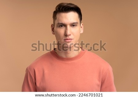 Portrait of attentive self confident man looking at camera with serious expression, unsmiling determined business man. Indoor studio shot isolated  Royalty-Free Stock Photo #2246701021