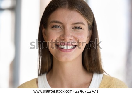 Cropped shot face beautiful young 30s happy woman standing indoor smile looking at camera feels satisfied. Attractive appearance, positive emotions, millennial generation female portrait, dental-care Royalty-Free Stock Photo #2246712471