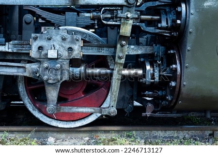 A close-up of a steam locomotive's propulsion system. Steam locomotive standing on the tracks, photo taken in natural lighting conditions. Royalty-Free Stock Photo #2246713127
