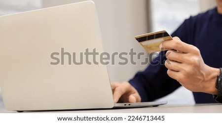 Businessman holding credit card for online shopping bill on computer, positive man shopping online remote payment , smart payment concept individual bank