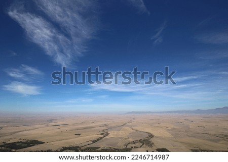 Distant view, blue sky and wispy clouds Royalty-Free Stock Photo #2246714987