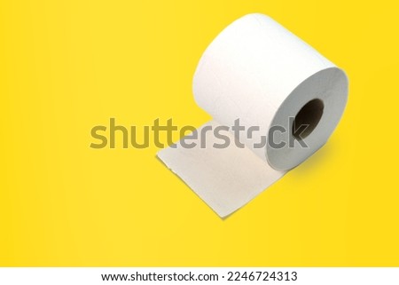 Single recycled toilet paper roll Isolated on yellow background, copy space.