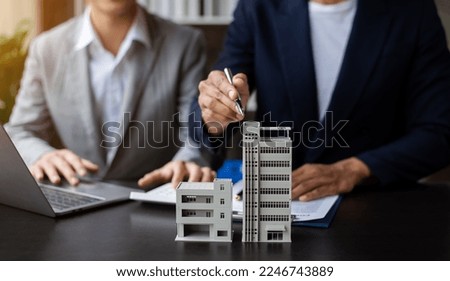 Salesman Hands On House Model , Small Toy House Small Mortgage Property insurance and concepts real estat in office