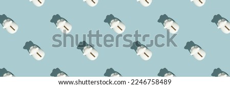Banner White piggy banks on blue background. Financial and money saving pattern concept flat lay