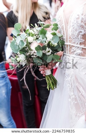 Beautiful delicate bouquet in the hands of the bride. wedding exhibition. Vertical photo
