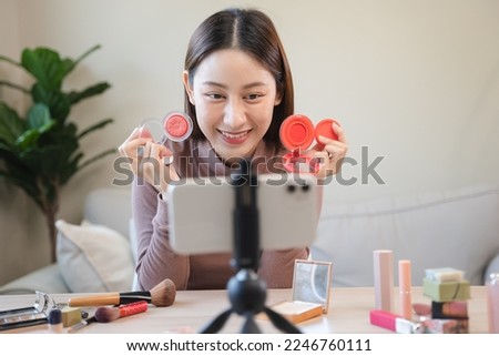 asian female beauty social media influencer livestream marketing cosmetics a make up tutorial via smartphone. Royalty-Free Stock Photo #2246760111