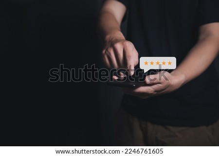 Close up Man hand using smartphone with five star icon for feedback service satisfaction, Customer service experience satisfaction survey.