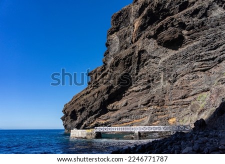 Active on Tenerife, Canary Islands: The Masca Gorge in the northwest - guided hike through the famous, unique gorge, Exit to the sea with jetty Royalty-Free Stock Photo #2246771787