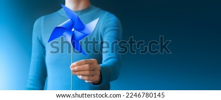 Woman hold paper wind tuaESG and Clean Energy Concept. Close-up of Wind Turbine Paper. Decrease Carbon and Produce a Green Power. World Earth Day, Sustainable Resources, Environmental and Ecology Care Royalty-Free Stock Photo #2246780145
