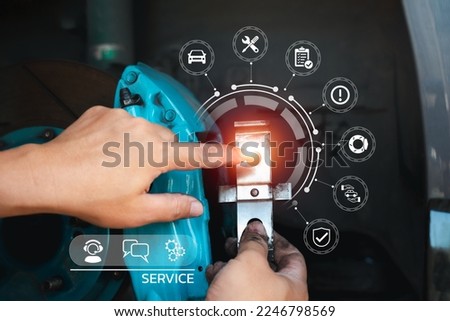 Car service and maintenance concept with customer service icon, Serviceman holding part of car brake system and showing basic maintenance icon and warranty after service with brake calliper background
