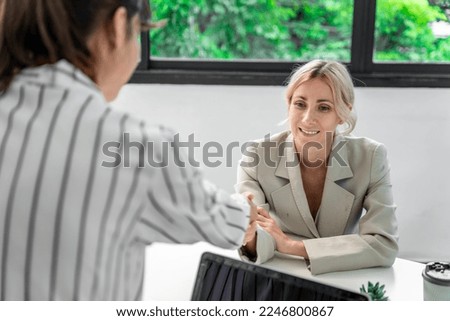 Businesswoman working at the company talking to colleagues, teamwork.