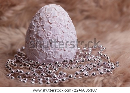 easter background in pink with egg and pearls