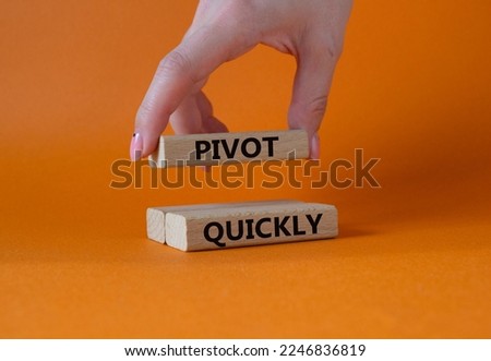 Pivot quickly symbol. Wooden blocks with words Pivot quickly. Businessman hand. Beautiful orange background. Business and Pivot quickly concept. Copy space.