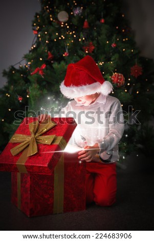 Composite image of Child opening his christmas present against snow