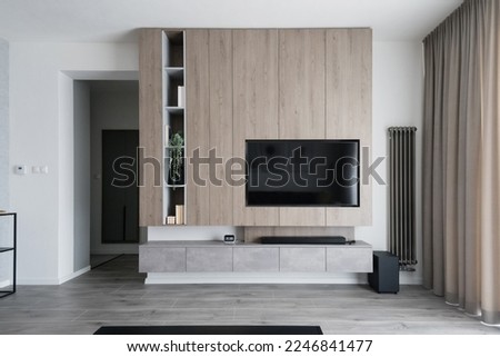 Modern living-room with wall and built in TV Royalty-Free Stock Photo #2246841477