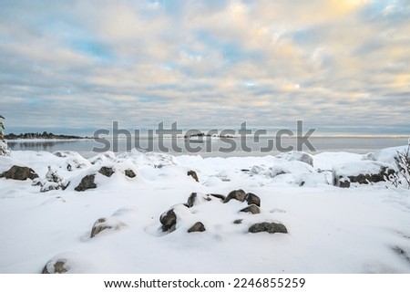 Panoramic sunset through the horizon. Winter wonderland scenery in scenic golden evening light at sunset with clouds and long shadow. tranquil nature windmil copy space background.