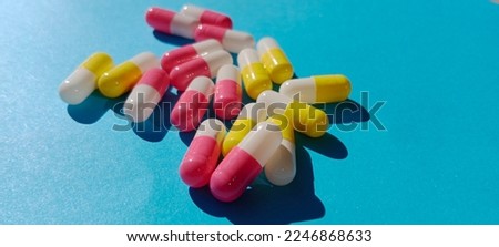 medicine in the form of capsules on a blue background