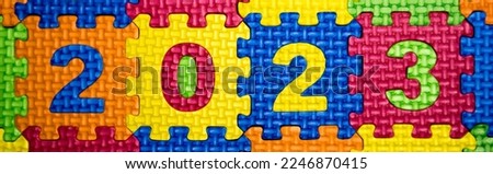 Numbers in square puzzles. Multicolored figures. Number 2023 year.
