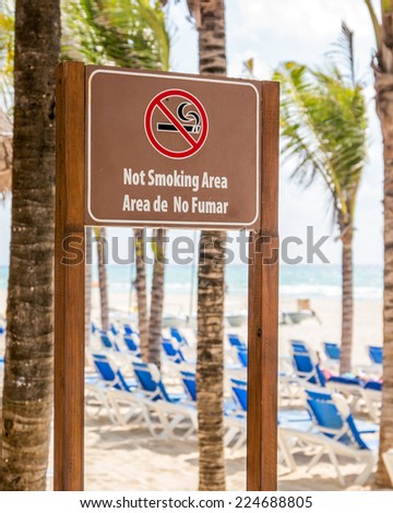 Not smoking area wooden sign at the beach