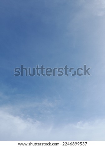 Beautiful white clouds on deep blue sky background. Elegant blue sky picture in daylight. Large bright soft fluffy clouds are cover the entire blue sky.