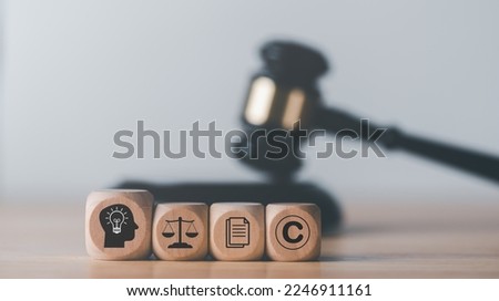wooden blocks and Wooden judge gavel on the table, concept of copyright or intellectual property patent protection of copyright infringement proprietary declaration Legitimate innovations Royalty-Free Stock Photo #2246911161