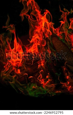  Sparks and flames.fiery wallpaper. Variegated flames and colorful sparks close-up.Multicolored flame.Firewood burning in bonfire.Burning bonfire.magical colorful flame.  Royalty-Free Stock Photo #2246912795