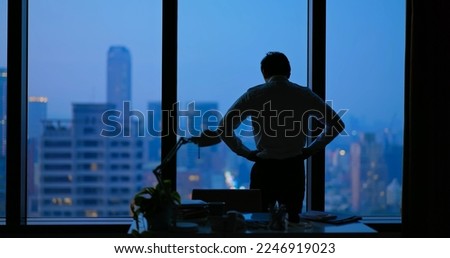 Rear view - Asian business man being frustrated standing in office hopelessly Royalty-Free Stock Photo #2246919023