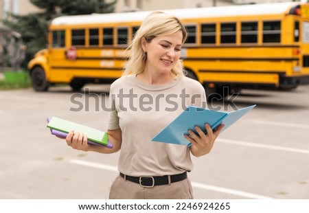Female Teacher Or Student With Digital Tablet Working At Table In College Hall