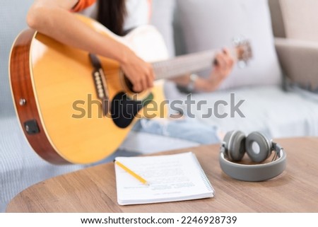 Concept of relaxation with music, Young asian woman playing music with lyrics and acoustic guitar. Royalty-Free Stock Photo #2246928739