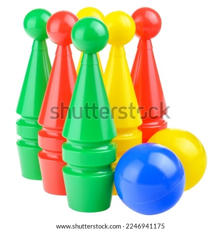 Multicolored bowling pins and a bowling ball isolated on a white background. Children's plastic bowling set, close-up. Active sports games, children's leisure.