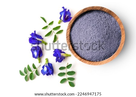 Butterfly pea flower with dried blue pea powder in wooden bowl isolated on white background, top view, flat lay.