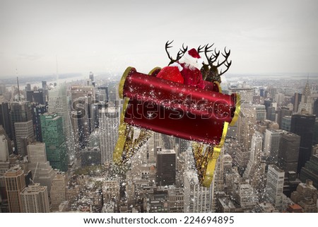 Santa flying his sleigh against city skyline