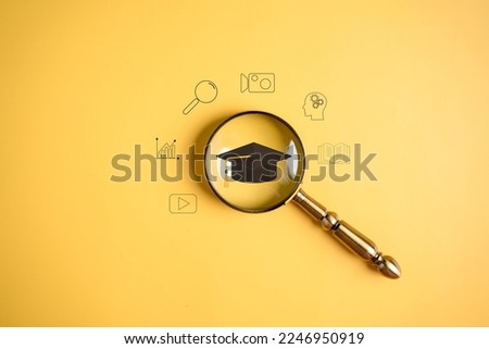 E-learning online class, magnifier focus to degree graduation cap icon, watching video on internet, webinar online, education on internet, e-learning, learning online with webinar, education concept.
 Royalty-Free Stock Photo #2246950919