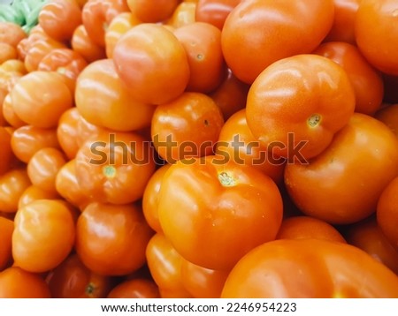 lots of fresh tomatoes on the counter at the supermarket