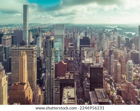 New York City Manhattan panorama with skyscrapers next to Central Park and busy street. Aerial high angle view