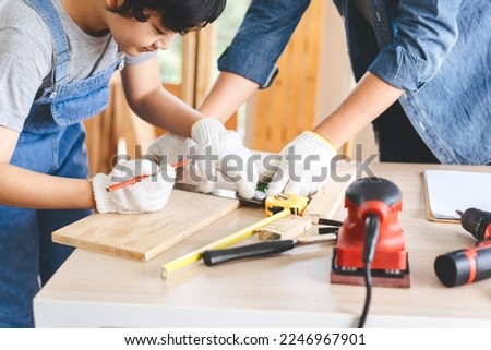 Southeast asian family father and son diy or repair at home concept. Dad teach using tools about carpenter or engineer education skill with child at workshop. Royalty-Free Stock Photo #2246967901