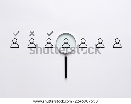 Employment and recruitment. Selection of the job candidates. Human resources management, interview and evaluation. Acceptance or rejection. Headhunting. Magnifying glass with employee symbols. Royalty-Free Stock Photo #2246987533