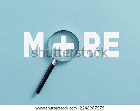 Aspiring for more achievement or improvement. Value added. Raising the bar. Raising expectations or standards. The word more with a plus sign and magnifying glass. Royalty-Free Stock Photo #2246987575