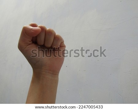 A White Asian Hand Fisting Upwards Symbol of Independence, Liberty, and Anti-Discrimination Against Ethnic Religions and Certain Groups. Isolated White Background. High Quality Closeup 3D Photography