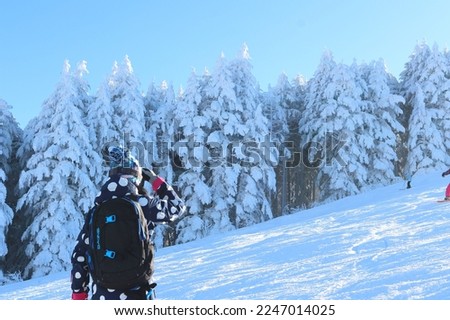 Skier blue sky background silhouette with the sun