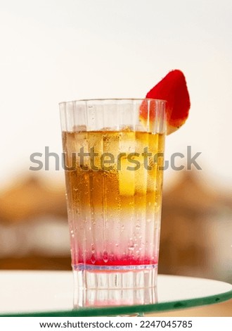 cold fruit cocktail on sunburst background