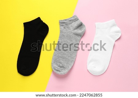 Different socks on colorful background, flat lay