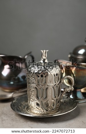 Vintage tea set on grey table, closeup. Space for text