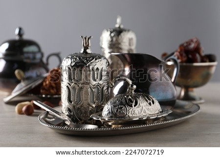 Tea, date fruits and Turkish delight served in vintage tea set on wooden table